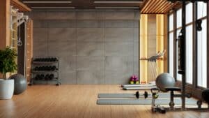 Modernes Fitnessstudio-Interieur mit Sport- und Fitnessgeräten vor einer Betonwand - 3D-Rendering